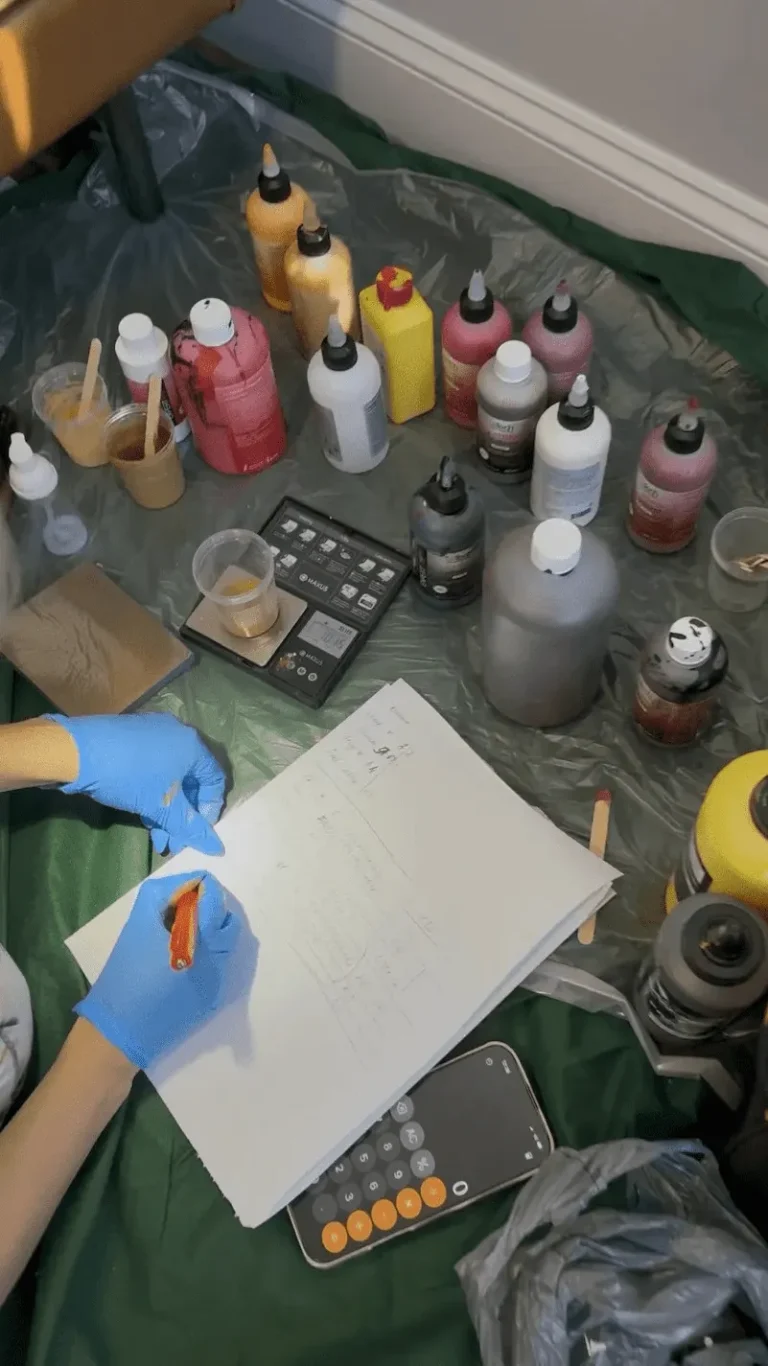 Technician preparing a custom color blend for aircraft leather restoration in Monroe, NC