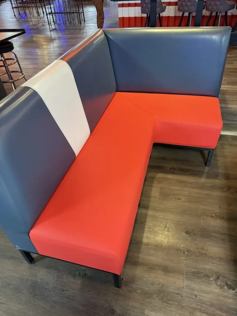 Restored red and gray vinyl booth seating at a bowling alley in Matthews, NC