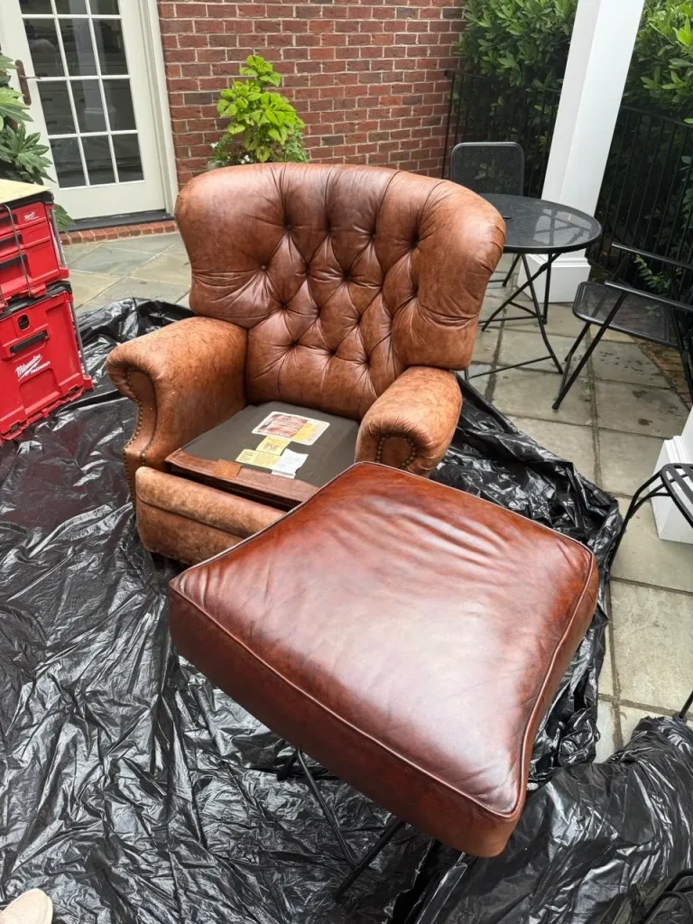 Luxury aniline leather recliner with its seat cushion removed during professional restoration