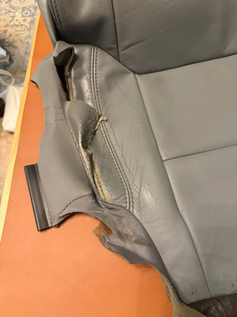 Damaged leather seat cover with a separated seam removed from a luxury Mercedes GLS in Indian Land, SC