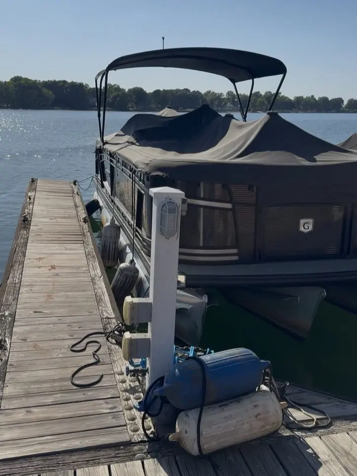 Pontoon boat at a dock in Cornelius, NC before an on-site seat seam repair