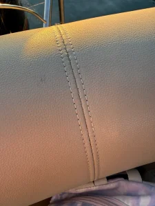 Close-up of a repaired decorative French seam on marine vinyl boat upholstery